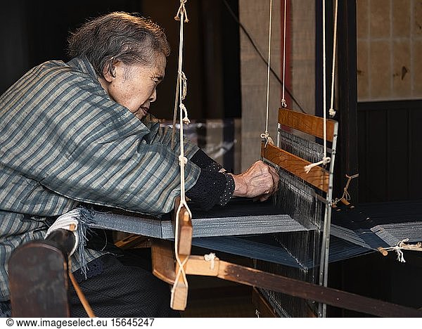 Old Japanese woman weaving at the loom  Hida Minzoku Mura  Hida no Sato  Takayama  Japan  Asia