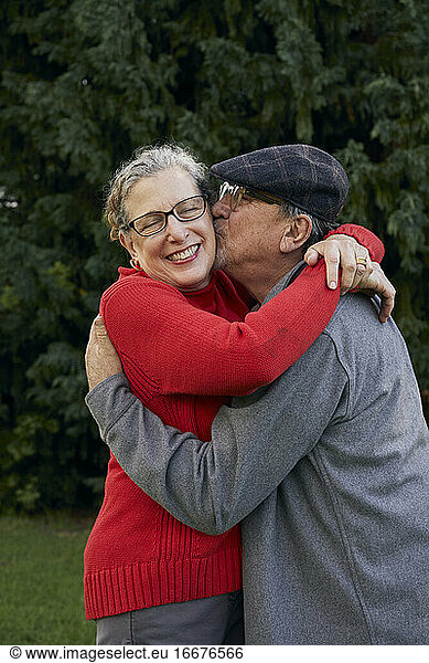 Old Man kissing wife on the cheek