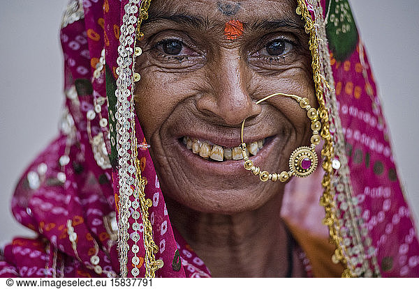 Old Rajasthani woman with huge nose ring and dirty teeth