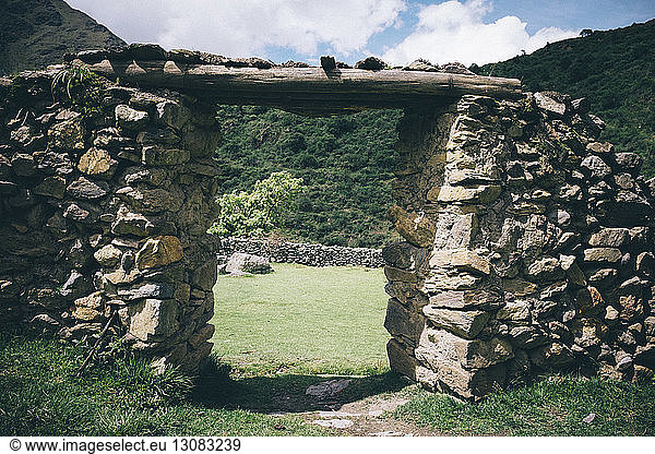 Old ruin on field against mountains