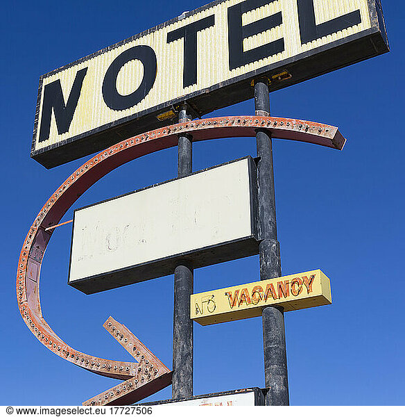 Old rusting Motel sign by the roadside.