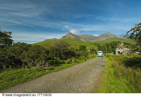 Old 1960's Vw Van Coming Down The Road With The Hills Of The Black Cuillin Behind; Glen Brittle  Isle Of Skye  Schottland