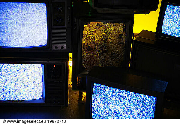 Old televisions showing static.