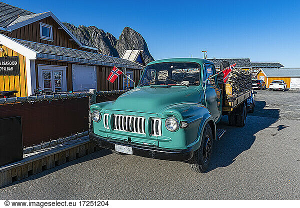 Old truck parked by cottage in harbour of Reine  Lofoten  Norway