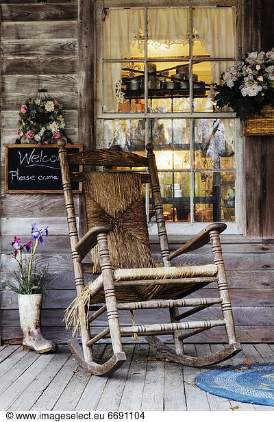 Old Wooden Rocking Chair on a Wooden Porch