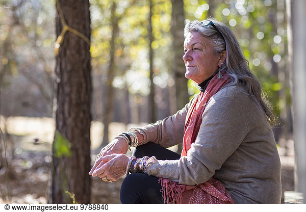 Older Caucasian woman sitting outdoors