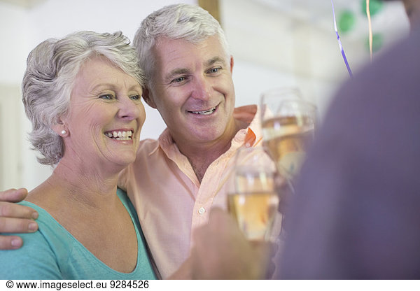 Older couple celebrating with drinks