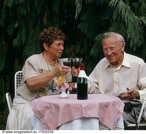Older couple drinking red wine  terrace
