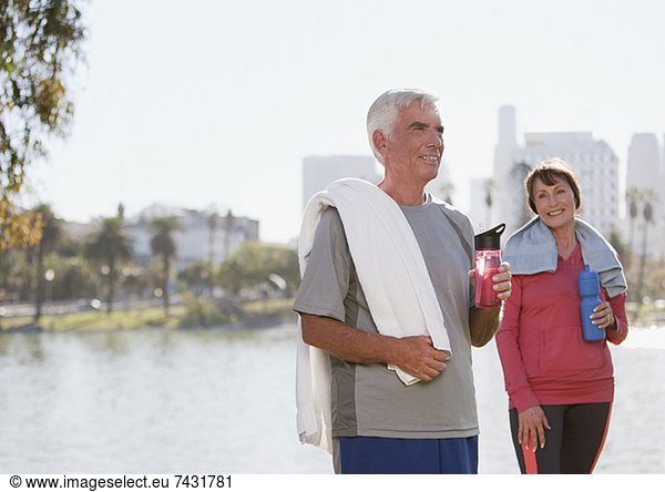 Older couple drinking water after workout