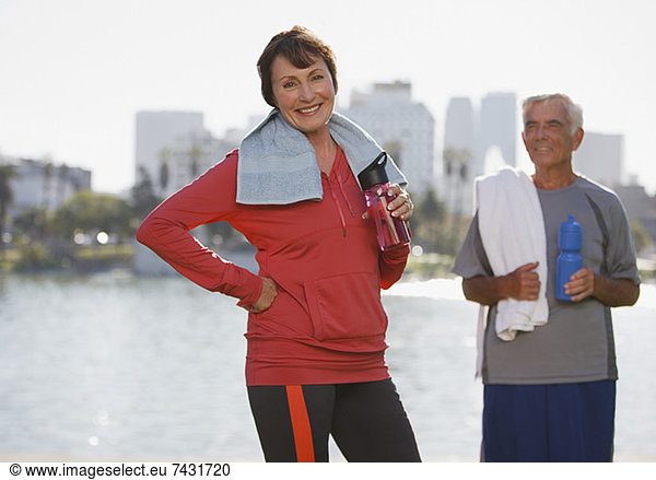 Older couple drinking water during workout