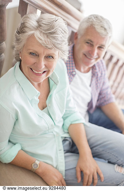 Older couple sitting together on stairs