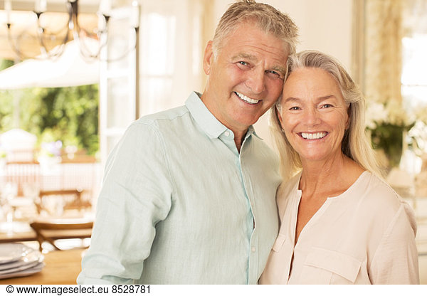 Older couple smiling indoors