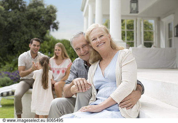 Older couple smiling on porch