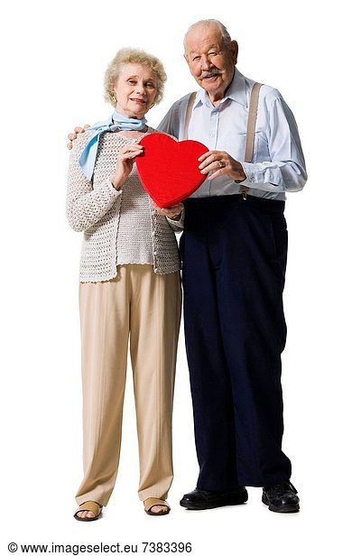 Older man giving wife Valentines chocolate