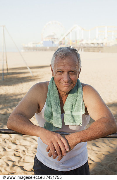 Older man relaxing after workout on beach