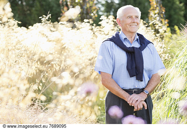 Older man smiling outdoors