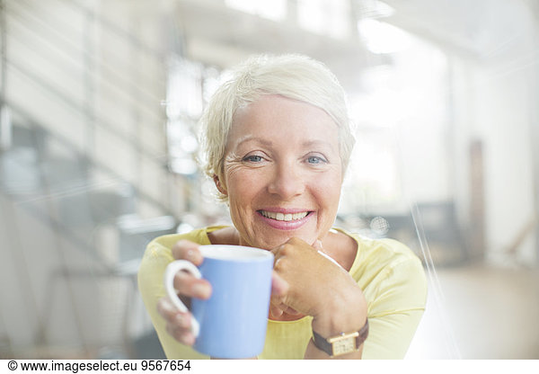 Older woman drinking cup of coffee