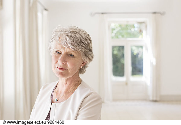 Older woman in empty living room