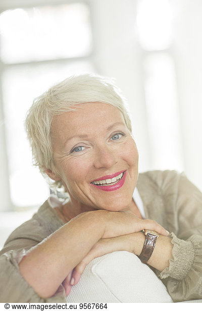 Older woman smiling on sofa