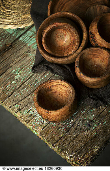 Olive wood bowls on a green table.