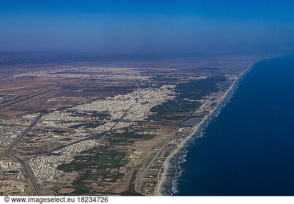 Oman  Dhofar Governorate  Salalah  Aerial view of desert city and coastline of Persian Gulf