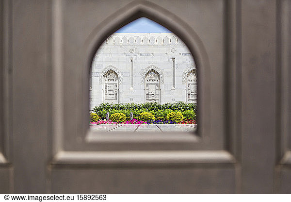 Oman  Muscat  Garden of Sultan Qaboos Grand Mosque seen through arch-shaped window