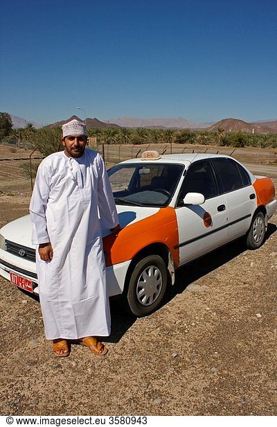 Omani taxi driver with his car in Jabrin