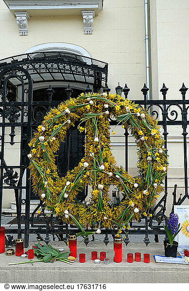 On the gates of the Embassy of Ukraine - Bucharest - Romania flowers  banner designs to pay tribute to the Ukrainians who died in the war