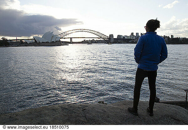 One man during sunset  staring at the Sydney Opera House