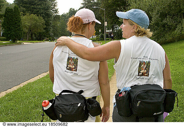 One sister puts her arm around the other during a breast cancer walk in Washington DC.