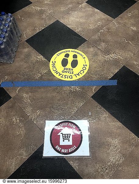 One way traffic Only Social Distance stickers on floor in supermarket aisle  Chicago  Illinois.
