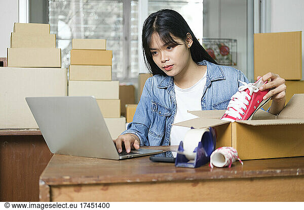 Online business owner preparing product to customer.