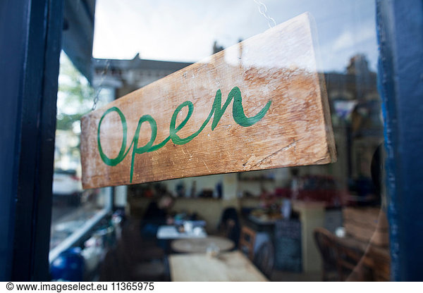 Open sign in window of cafe