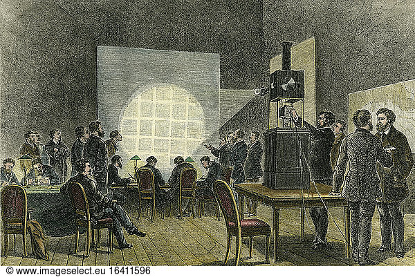 Optics / Laterna magica.Reproduction of photographic dispatches using a Laterna magica during the siege of Paris (Franco-Prussian War 1870/71). Wood engraving  later coloured. From: S.Th. Stein: “Das Licht im Dienste der wissenschaftlichen Forschung   Halle a. S. (W. Knapp) vol. 1  2nd edition  1885.