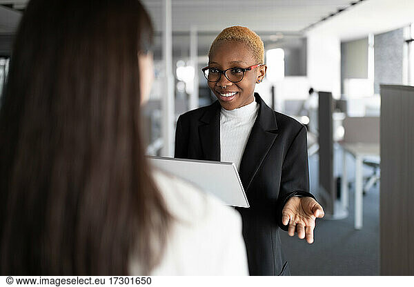 Optimistic black manager discussing project with colleague