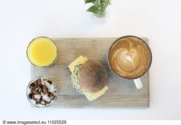 Orange juice  sandwich and cappuccino