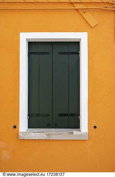 Orange wall with window  colorful house wall  closed shutters  colorful facade  Burano Island  Venice  Veneto  Italy  Europe