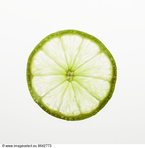 Organic lime slice on white background