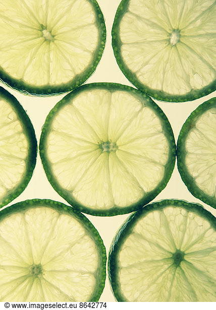 Organic lime slices on white background
