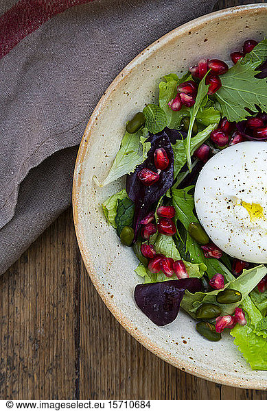 Oriental salad with mint  pistachios  pomegranate seeds and burrata cheese