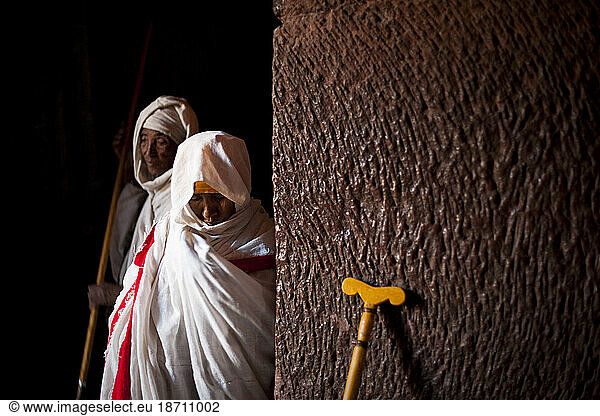 Orthodox Christian women awaits a blessing from the priest at Bet Gabriel-Rafael  Lalibela  Northern Ethiopia.