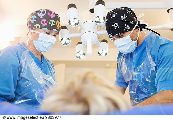 Orthopedic surgeons operating boy at clinic