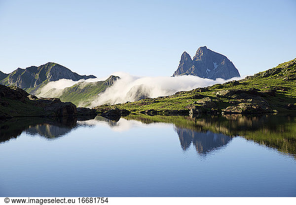 Ossau Peak reflected in Anayet lake in Tena Valley  Huesca province in Aragon  Pyrenees in Spain.