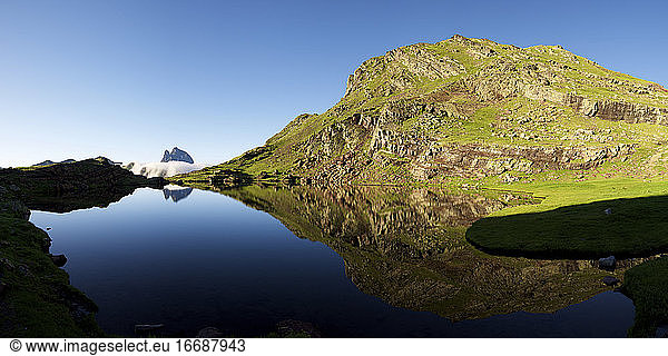 Ossau Peak reflected in Anayet lake in Tena Valley  Huesca province in Aragon  Pyrenees in Spain.