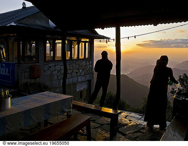 Outdoor patio scene during sunset at a lodge in the Annapurna region of Nepal.