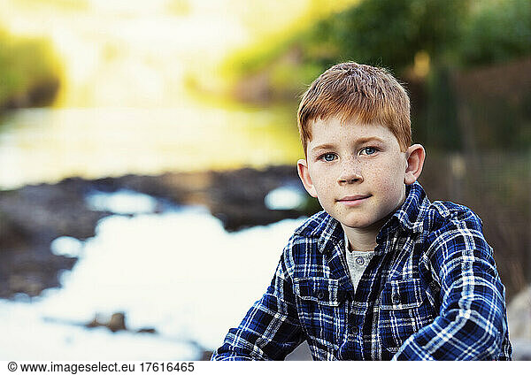 Outdoor portrait of a boy with red hair  freckles and blue eyes; Edmonton  Alberta  Canada