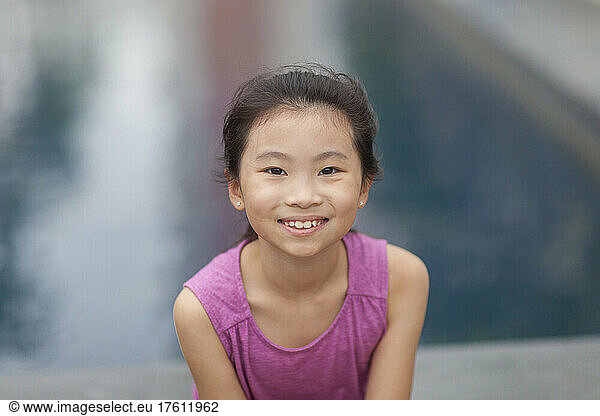 Outdoor portrait of a girl with water in the background; Hong Kong  China