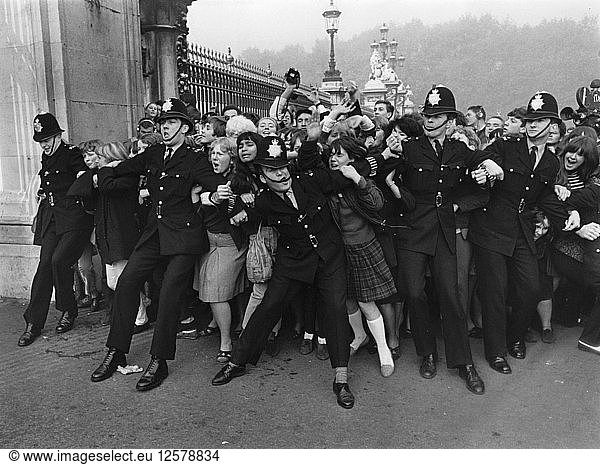 Outside Buckingham Palace when the Beatles received their MBEs  London  26 October 1965. Artist: Unknown