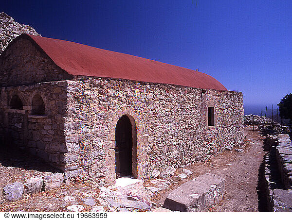 Outside the 17th C Church of Timia Zoni in the deserted village of Mikro Horio  Tilos  Greece