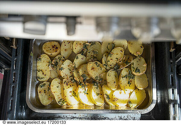 Oven roasted potatoes with garnished coriander in oven tray
